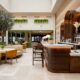 a bar with chairs and tables in a building No1 Lounge Jersey Airport
