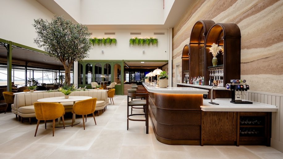 a bar with chairs and tables in a building No1 Lounge Jersey Airport