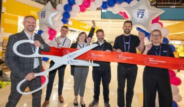 a group of people holding giant scissors Manchester Airport Terminal 2