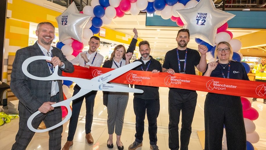 a group of people holding giant scissors Manchester Airport Terminal 2