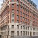a large brick building with many windows The Derby London City
