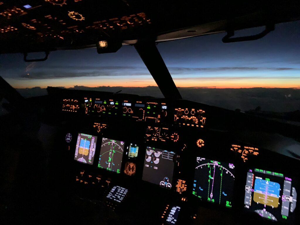 a cockpit of an airplane with many screens and a view of the sunset cameras in aircraft cockpits