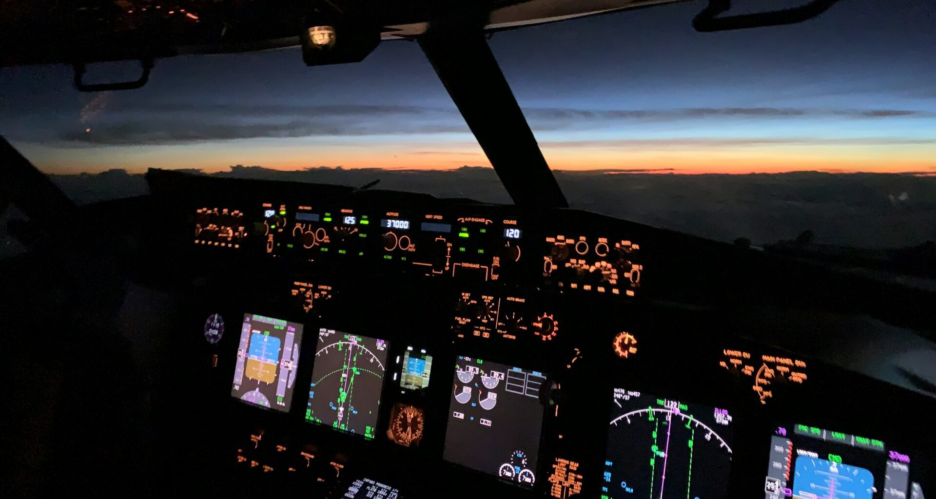 a cockpit of an airplane with many screens and a view of the sunset cameras in aircraft cockpits cameras on passenger aircraft