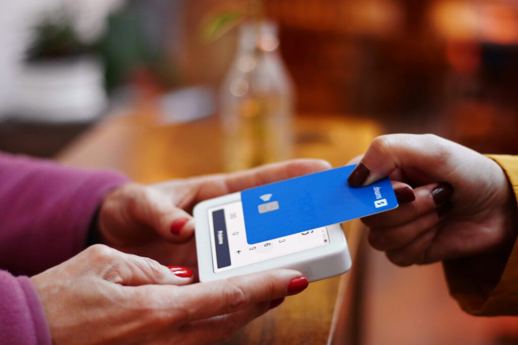 a person holding a credit card targeted Amex travel offers