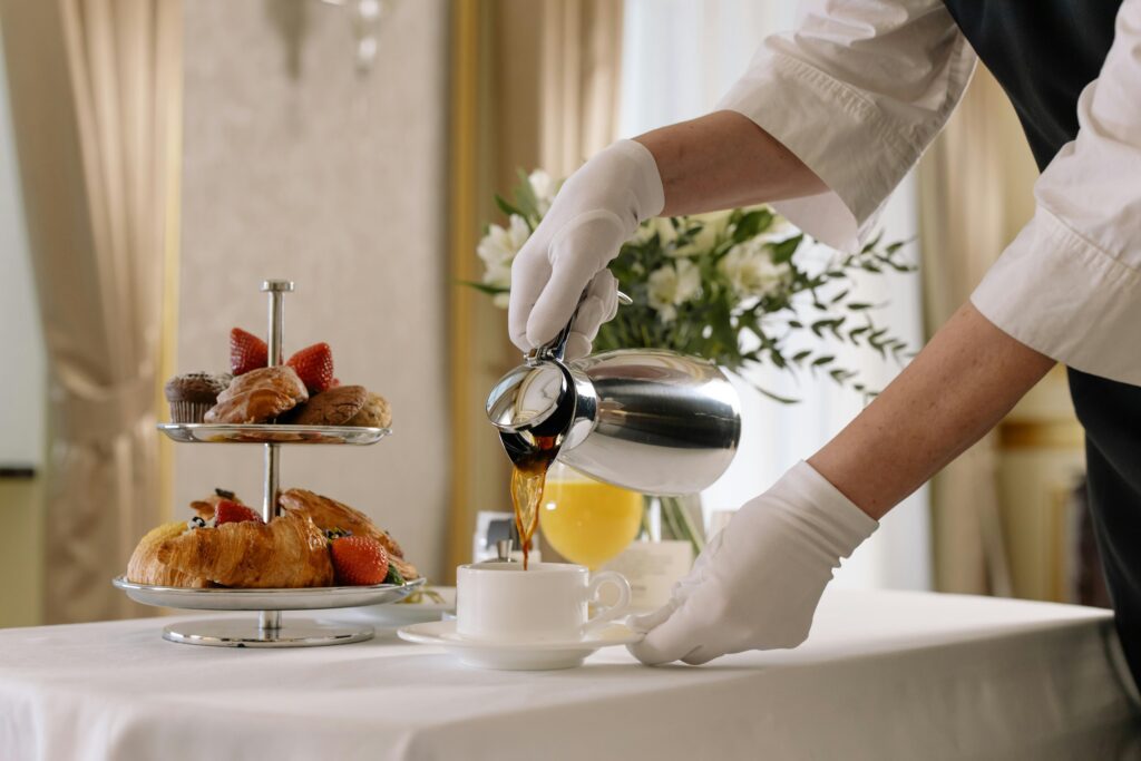 a person pouring coffee into a cup complimentary coffee in hotels