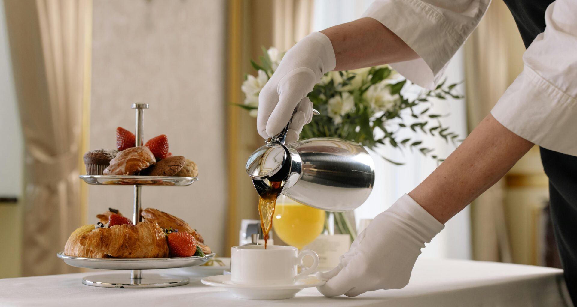 a person pouring coffee into a cup complimentary coffee in hotels